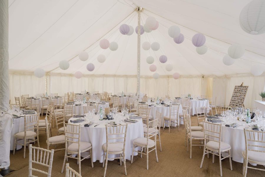 sailcloth wedding marquee Surrey king poles lined lanterns in roof round dining table hire and chairs wigwam marquees wedding