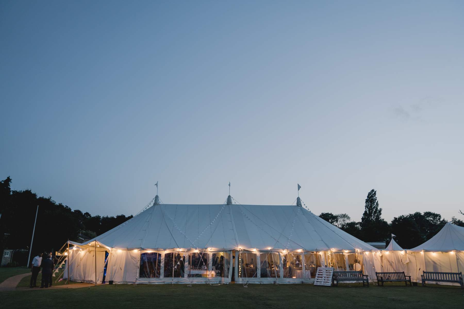 sailcloth wedding marquee Surrey king poles lined lanterns in roof round dining table hire and chairs wigwam marquees wedding