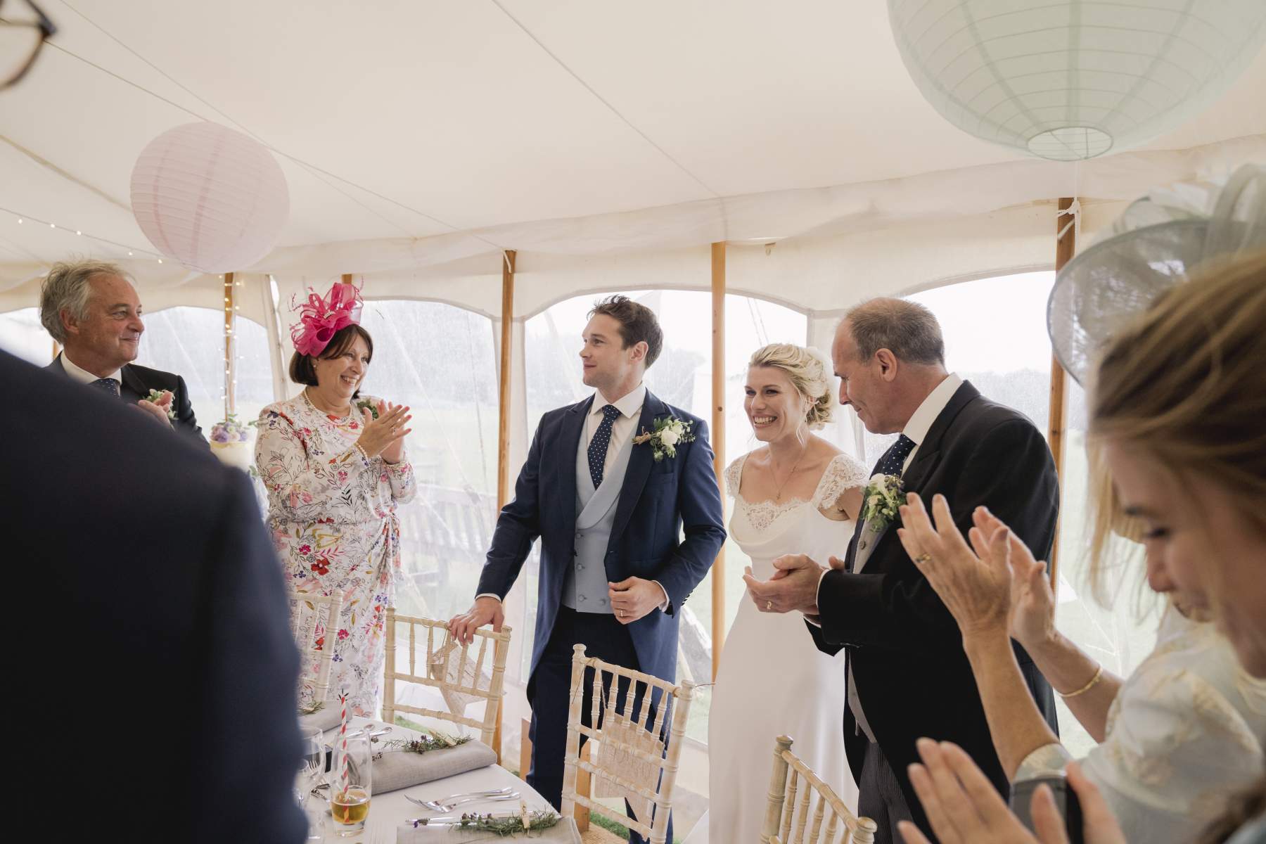 sailcloth wedding marquee Surrey king poles lined lanterns in roof round dining table hire and chairs wigwam marquees wedding