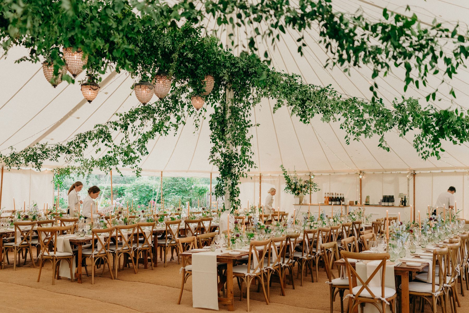 The dining tables ready for action with green floral canopy and beautiful lighting